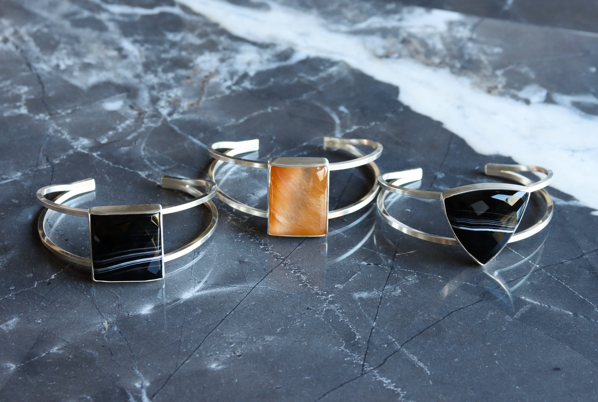 Collection of dual band silver cuffs with Botswana agate and golden rutile quartz